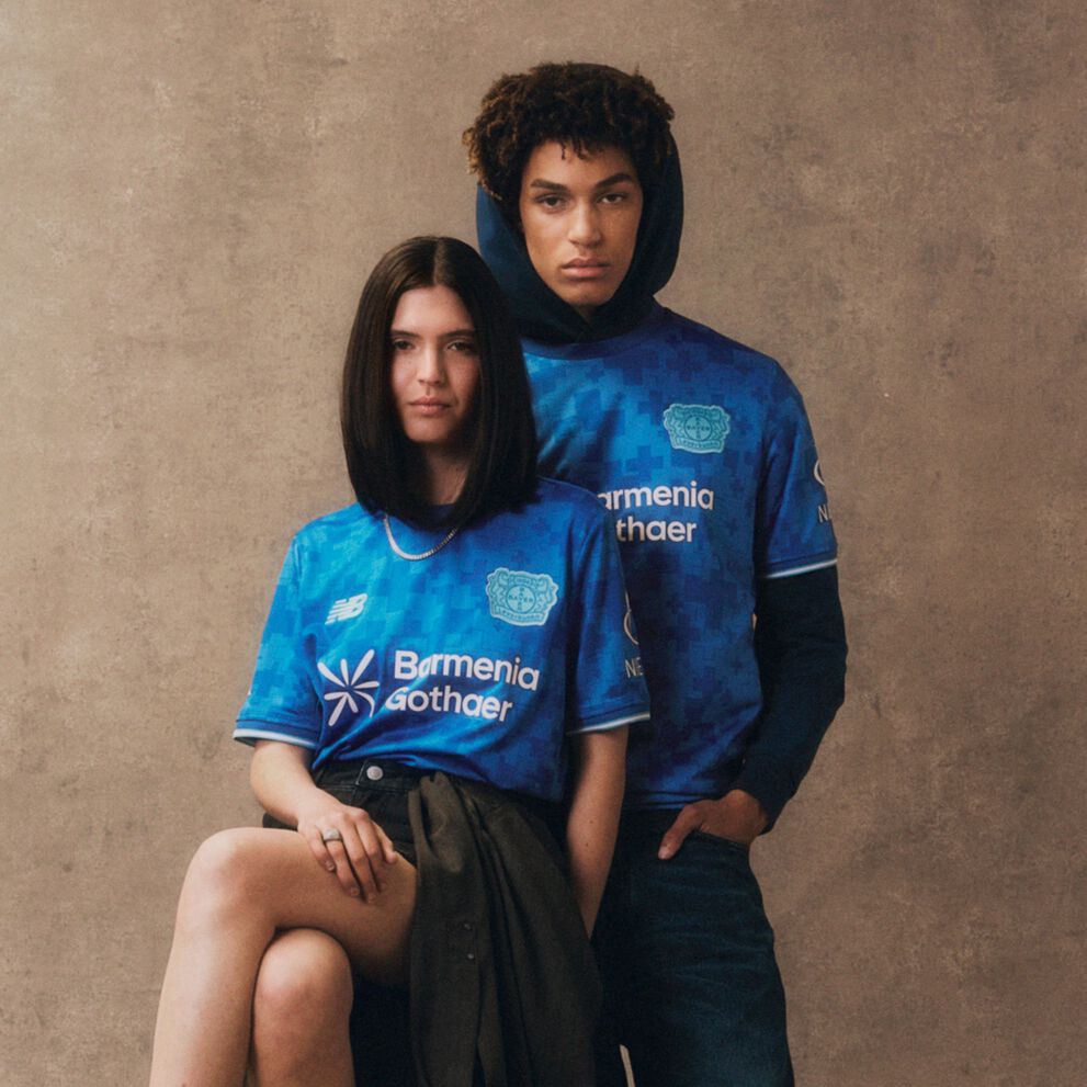 Young couple wearing blue soccer jerseys. 
